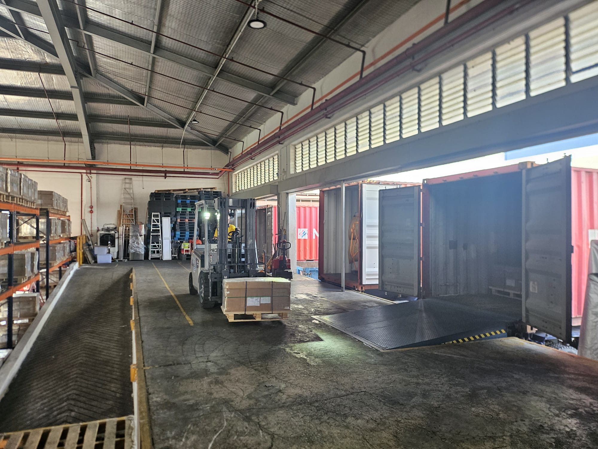 Forklift loading a shipping container